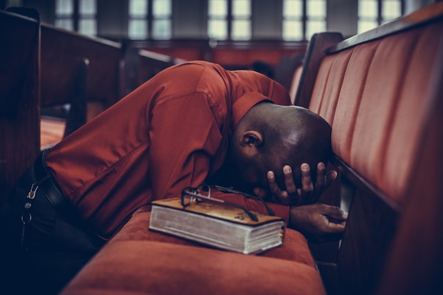 picture of a man praying in church